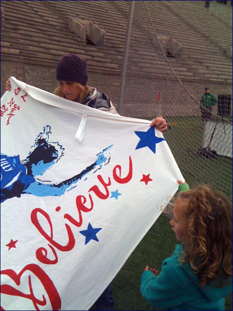 lilly holds her banner